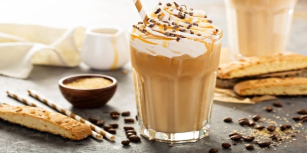 A glass of coffee with whipped cream and chocolate chips AI-generated content may be incorrect.
